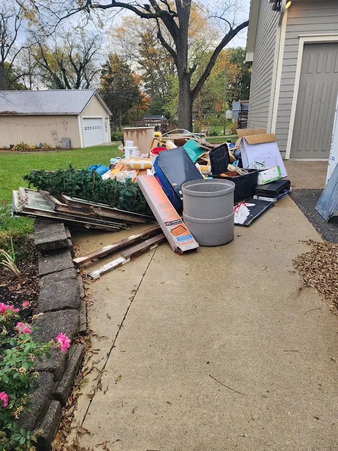 Dumpster being loaded with debris for 12 Yard Dumpster Rental in Denville